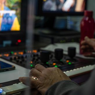 The operator operates the remote control at the TV